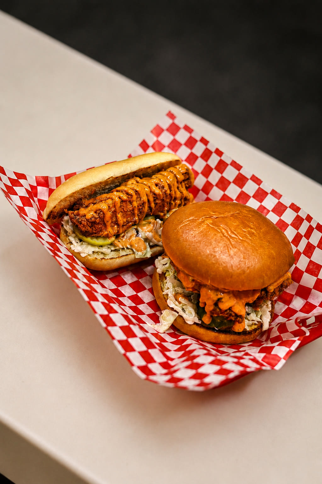 Kluckin Chicken sandwiches on checkered paper